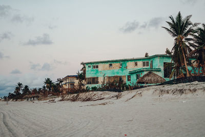 Scenic view of beach against cloudy sky