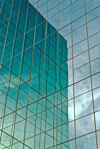 Low angle view of modern building with reflection