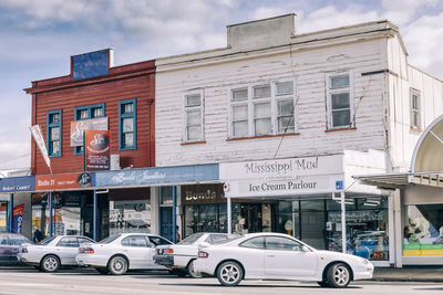 Vehicles on road against buildings in city