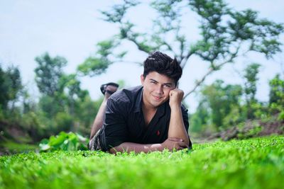 Portrait of smiling young man on field