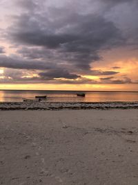 Scenic view of beach against sky during sunset