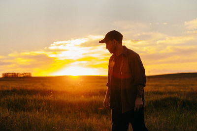 Portrait of a person in a field at sunset