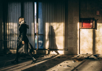 Side view of woman walking in building