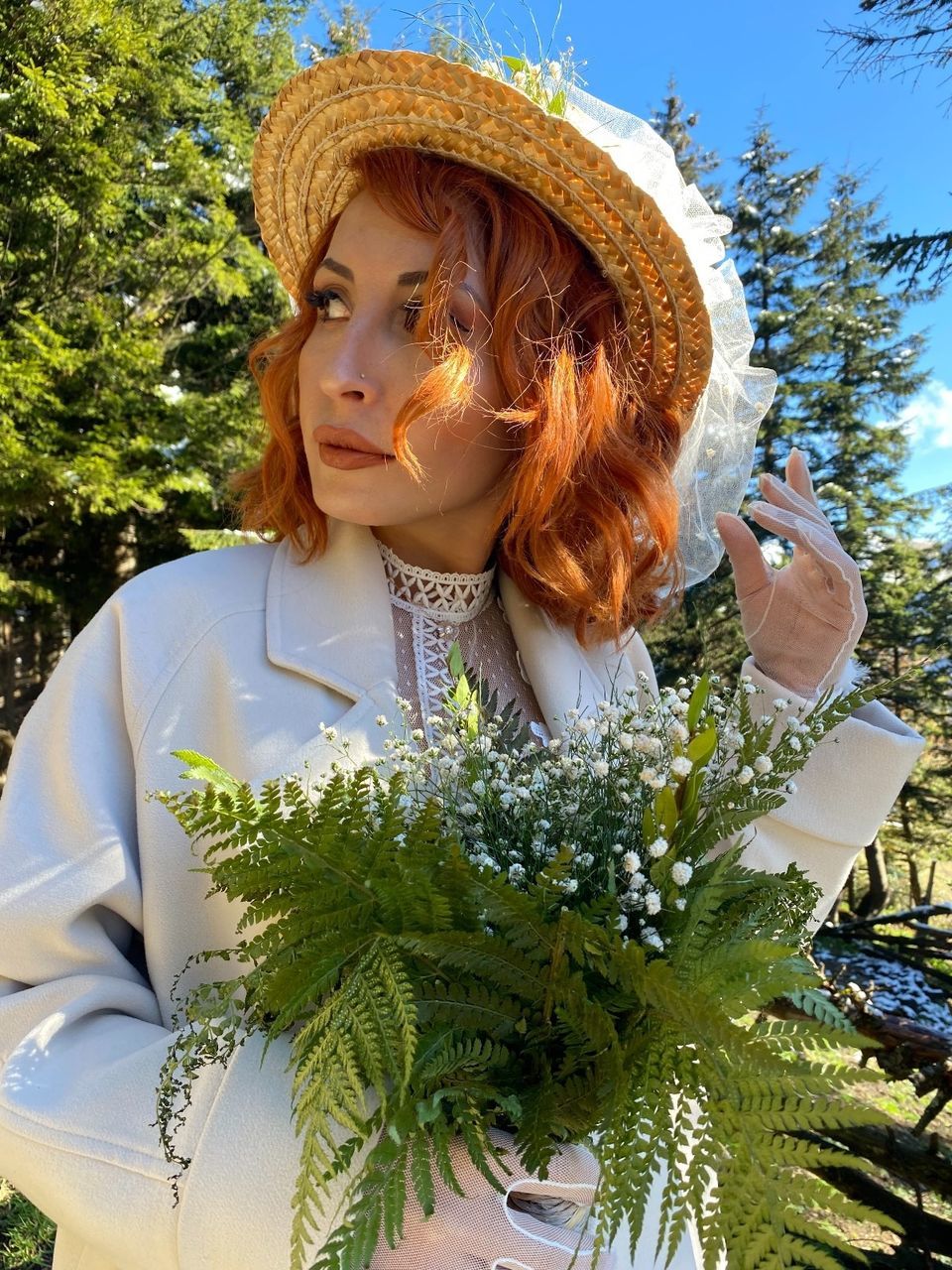 plant, one person, nature, flower, women, tree, clothing, hat, adult, young adult, portrait, day, leisure activity, lifestyles, looking, spring, growth, sunlight, front view, outdoors, female, waist up, standing, sun hat, green, hairstyle, fashion, casual clothing, sky, beauty in nature, person, holding, looking away, redhead, child, long hair, leaf