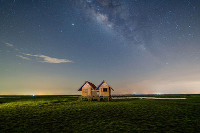 Built structure on field against sky at night