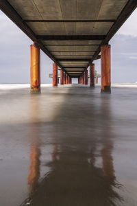 Bridge over sea against sky