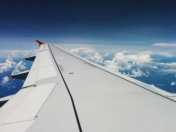 Low angle view of airplane wing against sky