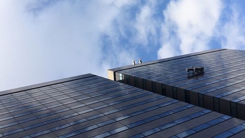 Low angle view of building against cloudy sky