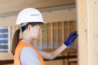 Young woman working in a workshop as artisan manual worker