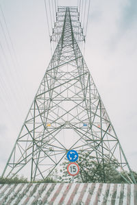 Low angle view of electricity pylon against sky