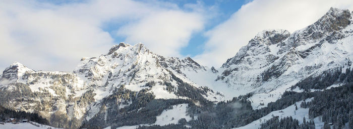 Panoramic view of snowcapped mountains against sky