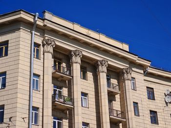 Low angle view of building against clear blue sky