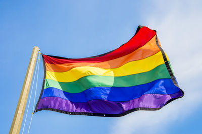 Low angle view of flag against blue sky