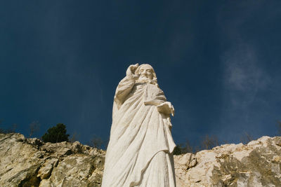 Low angle view of statue against sky