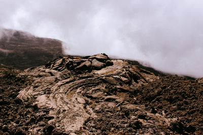 Smoke emitting from volcanic mountain against sky