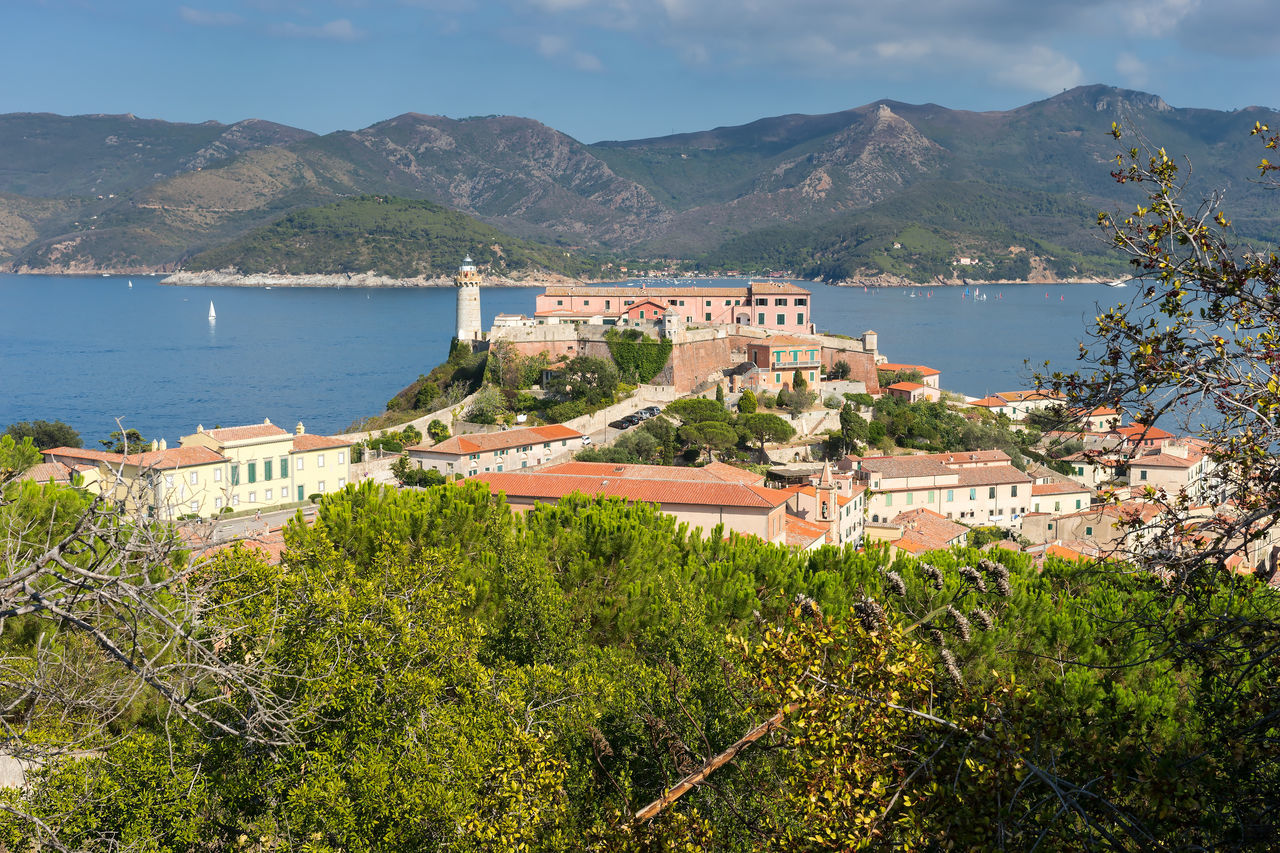 sea, coastline, mountain, water, travel destinations, building exterior, scenics, architecture, sky, beach, outdoors, city, harbor, no people, day