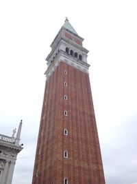 Low angle view of clock tower against sky