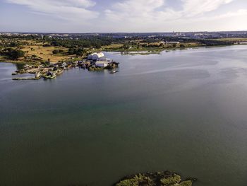 Aerial view of sea and buildings against sky