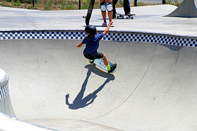 Full length of boy skateboarding on skateboard