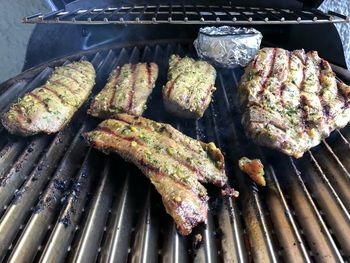 High angle view of meat on barbecue grill