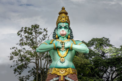 Low angle view of statue against sky, batu caves, kuala lumpur