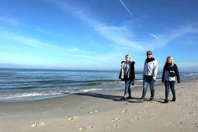 People on beach against sky