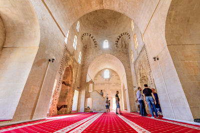 People walking in corridor of building