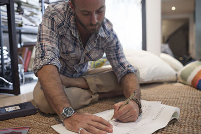 Young man writing music