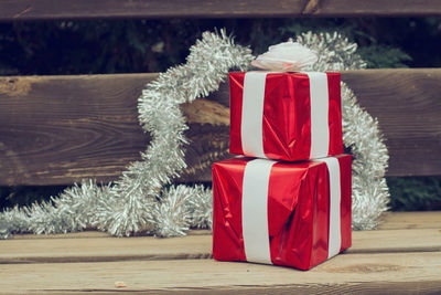 Close-up of red christmas present on wooden table