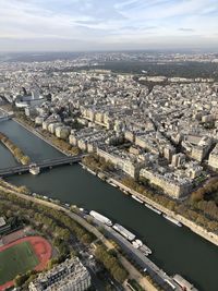 High angle view of river amidst buildings in city against sky