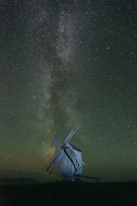 Traditional windmill against star field at night