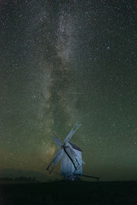 Low angle view of windmill against sky at night