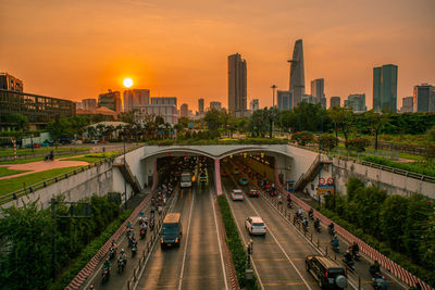 High angle view of illuminated city at sunset