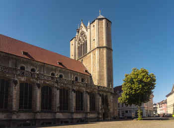 Low angle view of historic building against clear blue sky