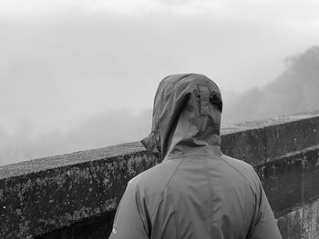 Rear view of woman standing against the sky