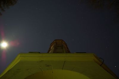 Low angle view of illuminated building against sky at night