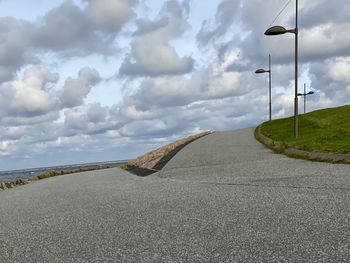 Road by street against sky