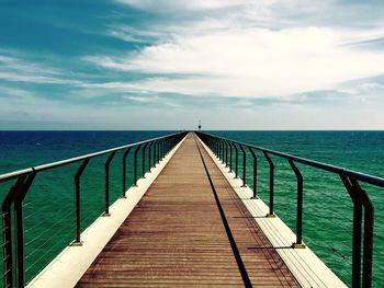 Pier over sea against sky