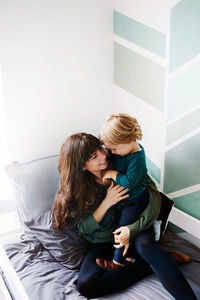 Young woman with daughter sitting outdoors