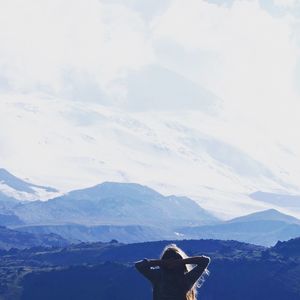 Rear view of man standing on cliff