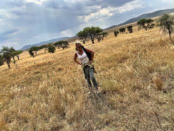 Full length of man standing on field against sky