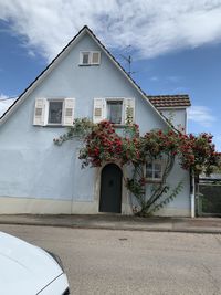 House by building against sky