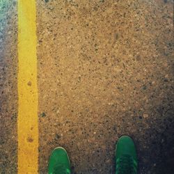 Low section of person standing on tiled floor