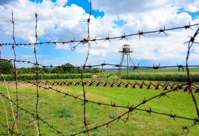 Fence on field against sky