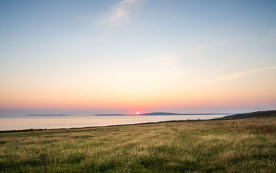 Scenic view of sea against sky during sunset