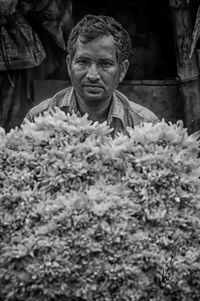 Portrait of man working on plants