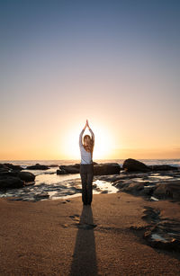 Rear view of man standing on beach