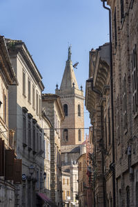 Low angle view of buildings against sky in city