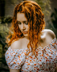 Close-up of young woman looking down outdoors