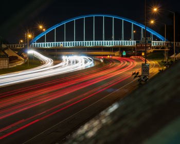 Light trails on bridge in city at night